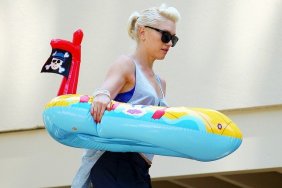 Gwen Stefani white tank top, blue pants cuffed, childs pool toy, sunglasses